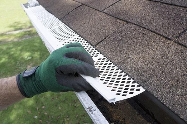 gutter guards help prevent ice dams by allowing water to flow freely and not become trapped in gutters